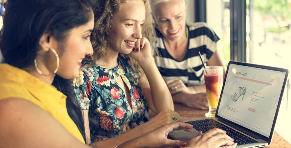 females shopping online on a laptop