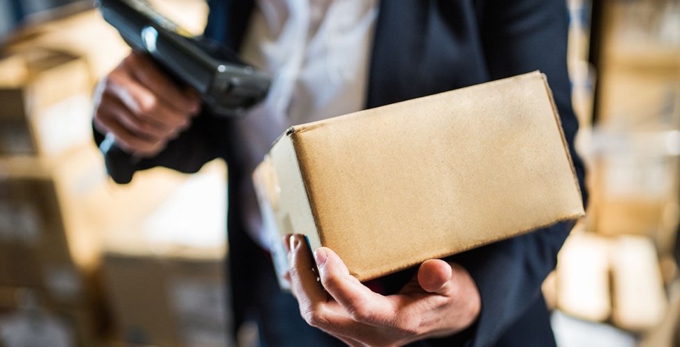 Person scanning parcel to be delivered