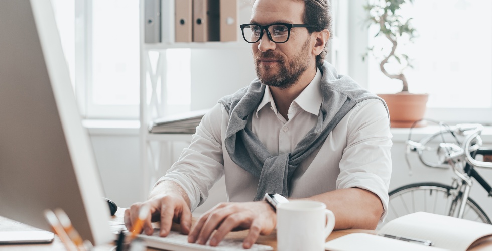 business man typing onto his computer